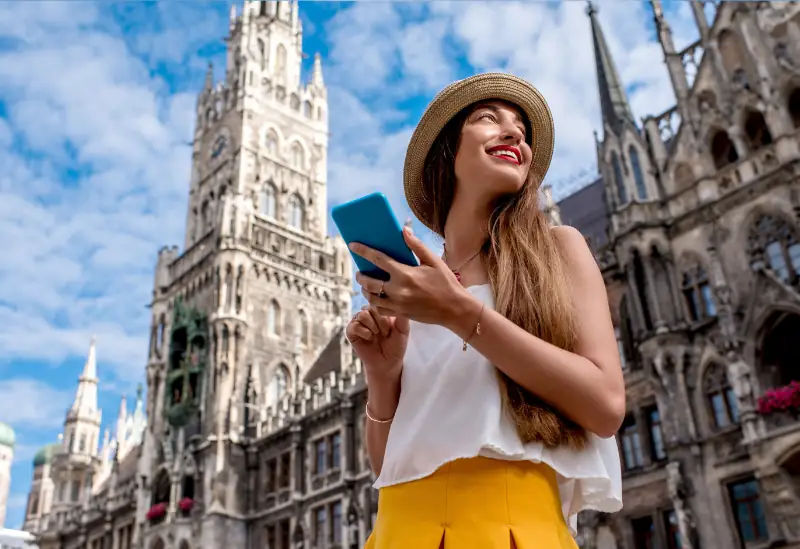 Backpacker using a budget travel guide to plan expenses