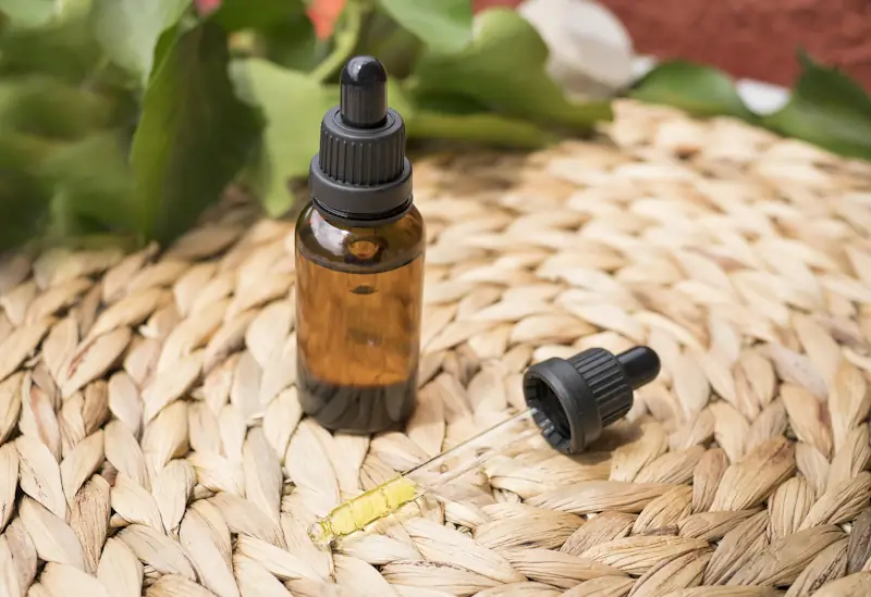 CBD oil bottle and dropper representing savings with voucher codes