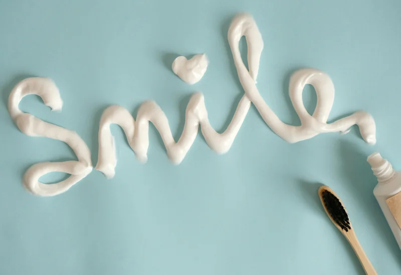 A bright, smiling text design surrounded by discount codes and a home teeth whitening kit