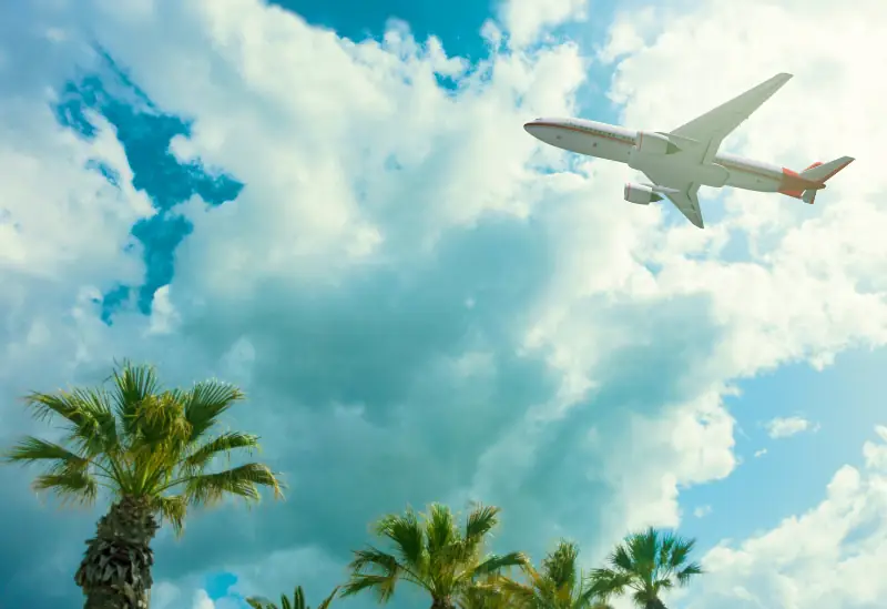 Passenger jet flying above the clouds – discover cheap flights for NHS workers.