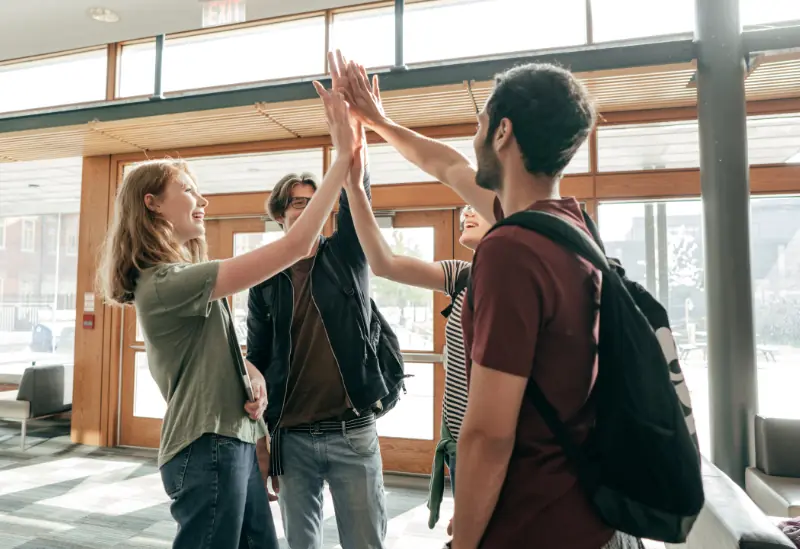 Group of students celebrating savings from student discounts.