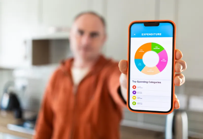 A man using a popular UK-based personal finance app showing a user-friendly budget tracker.
