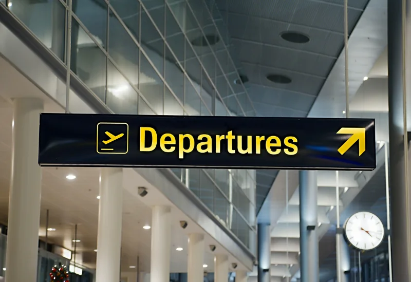 Airport departures sign showing flight information for travellers.
