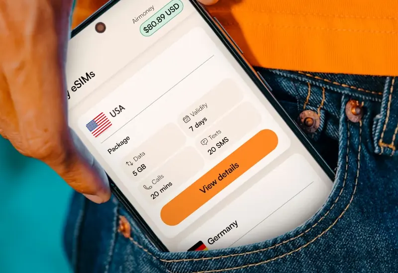 Person holding a phone showing a US eSIM plan