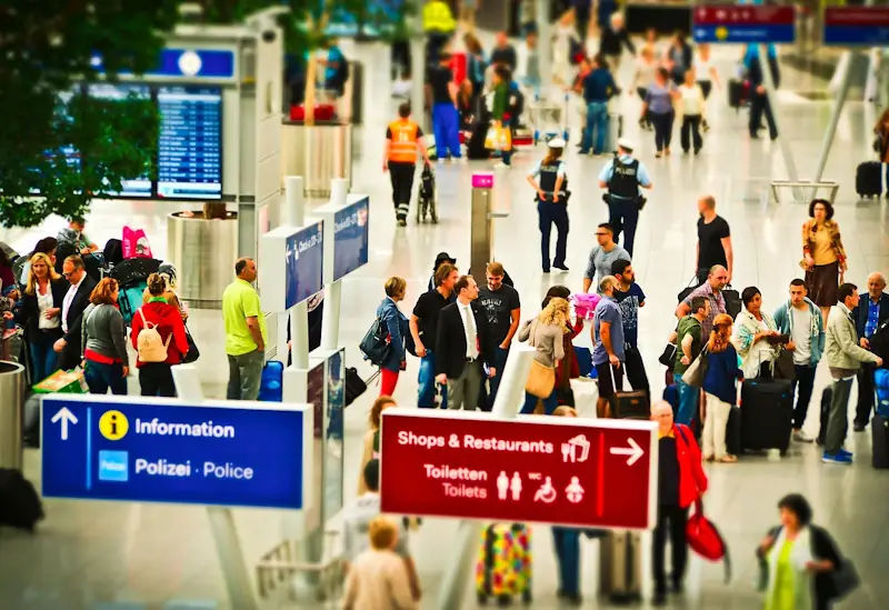 UK travellers queuing at an airport departure gate while searching for cheap flights