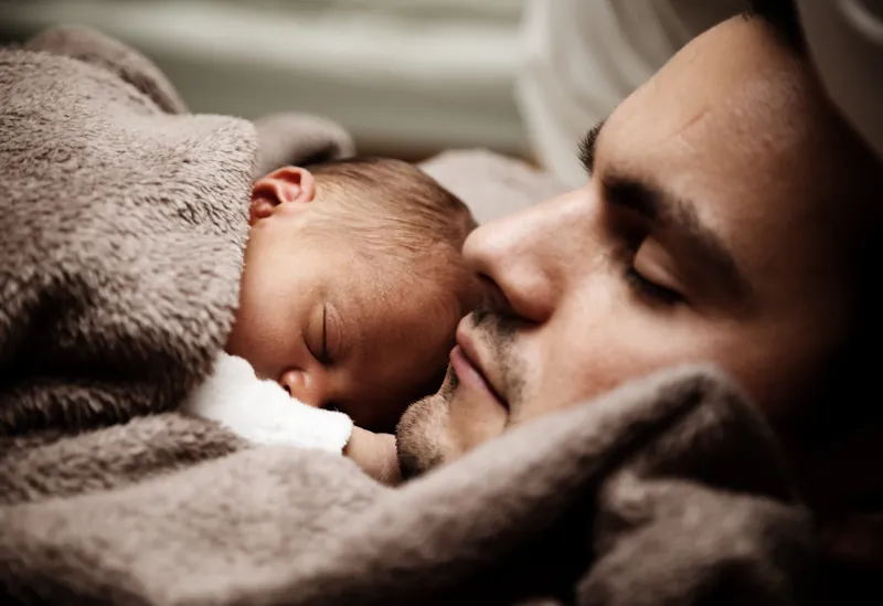 New parents at home with their baby, using the Savzz baby first year cost calculator to plan their budget