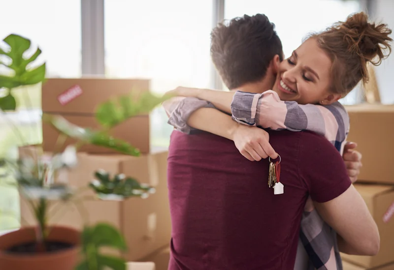 Young couple reviewing the true cost of buying their first home using the Savzz first-time buyer calculator