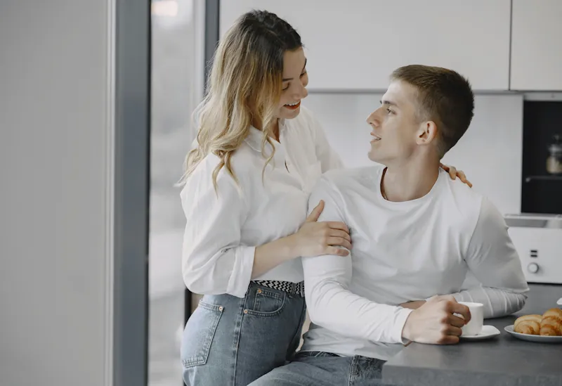 Couple spending time together at home in a relaxed kitchen setting.