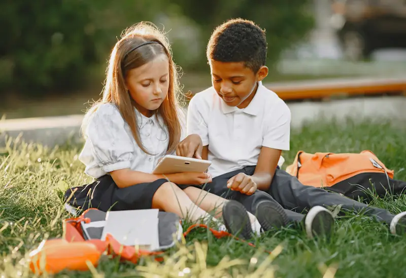 Children in school uniform using the Savzz school uniform cost calculator to help parents plan their back‑to‑school budget