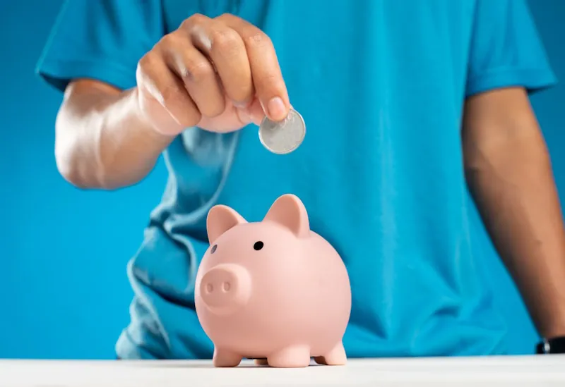 Pink piggy bank on a colourful background representing different saving personalities.