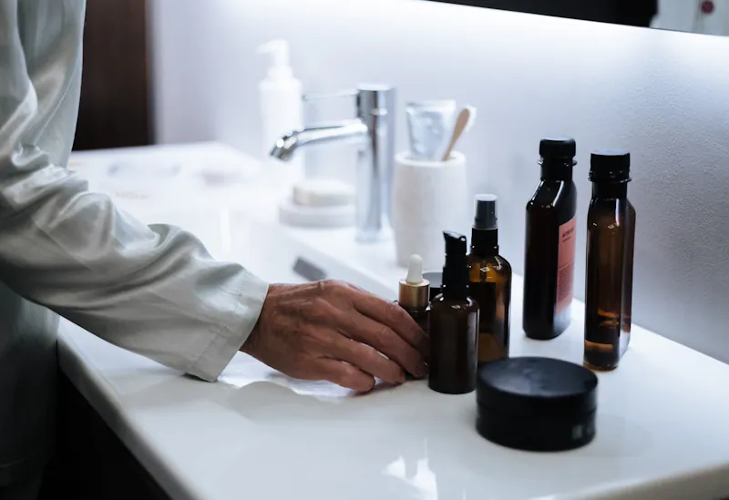 Skincare products arranged on a bathroom counter.